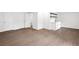 Hardwood floored bonus room featuring wet bar with white cabinetry, shelving, and stainless faucet at 630 Pennylake Ct, Stone Mountain, GA 30087