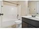 Bathroom with shower-tub combo, toilet, and dark vanity with white countertop at 7691 Brazos Trl, Fairburn, GA 30213