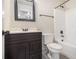 Standard bathroom with dark vanity, white countertop, and a shower-tub combo at 7691 Brazos Trl, Fairburn, GA 30213