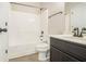 Standard bathroom featuring a white shower-tub combo, toilet, and dark vanity with white countertop at 7691 Brazos Trl, Fairburn, GA 30213