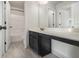 Bright bathroom with modern vanity, mirror, tile floors, and a shower-tub combo at 7691 Brazos Trl, Fairburn, GA 30213