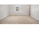 Bedroom featuring neutral walls, carpet, and trim with a window view at 7691 Brazos Trl, Fairburn, GA 30213