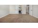 Bright bedroom featuring neutral walls, plush carpet, and double doors leading to an ensuite bathroom at 7691 Brazos Trl, Fairburn, GA 30213