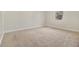 Carpeted bedroom features neutral walls, white trim, and a single window for natural light at 7691 Brazos Trl, Fairburn, GA 30213