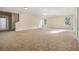 Spacious bonus room with neutral walls, plush carpet, and bright natural light from windows at 7691 Brazos Trl, Fairburn, GA 30213