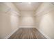 Walk-in closet with custom shelving and wood-look flooring at 7691 Brazos Trl, Fairburn, GA 30213