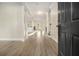 Inviting foyer with gleaming hardwood floors and views of the living spaces at 7691 Brazos Trl, Fairburn, GA 30213