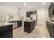 Modern kitchen featuring dark cabinets, stainless steel appliances, and granite countertops at 7691 Brazos Trl, Fairburn, GA 30213