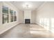 Spacious living room featuring a fireplace, large windows, and modern lighting at 7691 Brazos Trl, Fairburn, GA 30213