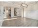 Spacious open-concept living room featuring modern lighting and hardwood floors at 7691 Brazos Trl, Fairburn, GA 30213