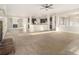 Large living space with carpeting and an open floor plan at 7691 Brazos Trl, Fairburn, GA 30213
