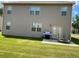 View of the backyard with a concrete patio area and ample lawn space at 11547 Hathaway Dr, Hampton, GA 30228