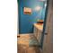A bathroom featuring blue walls, a white vanity with double sinks, and tiled floors at 11547 Hathaway Dr, Hampton, GA 30228