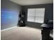 Versatile bonus room with carpet, a large window, projector and screen, and a dedicated desk space for work or hobbies at 11547 Hathaway Dr, Hampton, GA 30228