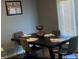 Dining room with table set for four with modern chairs at 11547 Hathaway Dr, Hampton, GA 30228