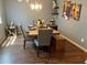 Charming dining room featuring a wooden table with seating for six, stylish decor, and hardwood floors for elegant dining at 11547 Hathaway Dr, Hampton, GA 30228