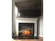 Modern electric fireplace with tile surround and large television above at 11547 Hathaway Dr, Hampton, GA 30228