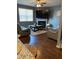 A modern living room with hardwood floors, fireplace, TV, and comfortable seating at 11547 Hathaway Dr, Hampton, GA 30228