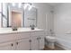 Bathroom featuring a double sink vanity and a tub with a tile surround at 1790 Abinger Ln, Lawrenceville, GA 30043