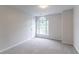 This is a bedroom with neutral walls, carpeted flooring, and natural light from the large window at 1790 Abinger Ln, Lawrenceville, GA 30043