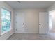 Bedroom with neutral walls and carpeted floors, a window, and two doors at 1790 Abinger Ln, Lawrenceville, GA 30043
