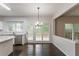 Charming dining area features stylish lighting and a view to the backyard at 1790 Abinger Ln, Lawrenceville, GA 30043