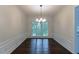 Dining room with hardwood floors features decorative molding and a chandelier at 1790 Abinger Ln, Lawrenceville, GA 30043