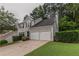 Charming two-story home features a two-car garage and well-maintained lawn at 1790 Abinger Ln, Lawrenceville, GA 30043