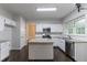 Bright kitchen features white cabinets, stainless appliances, granite counters, and island at 1790 Abinger Ln, Lawrenceville, GA 30043