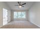 Spacious main bedroom features large window, neutral carpet, and ceiling fan at 1790 Abinger Ln, Lawrenceville, GA 30043