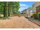 Spacious backyard features a fire pit, wooden fence, and mature trees, perfect for outdoor entertaining at 3059 Brookgreen Trl, Lawrenceville, GA 30043