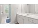 This bathroom offers a white vanity, mirror, and tiled shower with a window at 3059 Brookgreen Trl, Lawrenceville, GA 30043