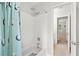 This bathroom showcases a shower and tub combination featuring white tiles, a shower head, and a shower curtain at 3059 Brookgreen Trl, Lawrenceville, GA 30043