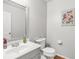 Clean bathroom with a white vanity, toilet, hardwood floors, and neutral wall color at 3059 Brookgreen Trl, Lawrenceville, GA 30043