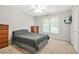 This bedroom has neutral walls, carpet, window, fan and includes a television for your comfort and enjoyment at 3059 Brookgreen Trl, Lawrenceville, GA 30043