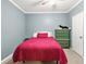 Cozy bedroom with a green dresser and a red bedspread at 3059 Brookgreen Trl, Lawrenceville, GA 30043