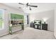 This bedroom includes a fan, large window, neutral walls, carpet, desk and storage at 3059 Brookgreen Trl, Lawrenceville, GA 30043