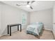 This cozy bedroom features a ceiling fan, large window, desk, neutral walls, carpet, and comfortable twin bed at 3059 Brookgreen Trl, Lawrenceville, GA 30043