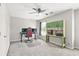 This bedroom includes a fan, large window, neutral walls, carpet, desk and storage at 3059 Brookgreen Trl, Lawrenceville, GA 30043