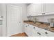 Butler's pantry features white cabinets, granite countertops, and decorative accents with coffee bar at 3059 Brookgreen Trl, Lawrenceville, GA 30043