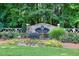 Stone community entrance sign for The Preserve with lush landscaping and a white fence in a wooded area at 3059 Brookgreen Trl, Lawrenceville, GA 30043