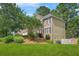 Two-story home featuring brick and siding, lush lawn and mature trees create private yard at 3059 Brookgreen Trl, Lawrenceville, GA 30043