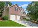 Beautiful brick two-story home featuring an attached two-car garage and a well-maintained front lawn at 3059 Brookgreen Trl, Lawrenceville, GA 30043
