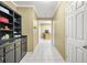 Hallway with white tile floors, built-in cabinets, and access to the kitchen area at 3059 Brookgreen Trl, Lawrenceville, GA 30043