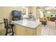 Kitchen features a breakfast bar with stone countertops and an open view to the living room at 3059 Brookgreen Trl, Lawrenceville, GA 30043