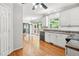 Well-lit kitchen featuring white cabinets, stainless steel dishwasher, hardwood floors and a view to the deck at 3059 Brookgreen Trl, Lawrenceville, GA 30043