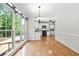 Open-concept kitchen with white cabinets and hardwood floors flowing into adjacent dining area at 3059 Brookgreen Trl, Lawrenceville, GA 30043