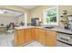 Efficient kitchenette with sink, light wood cabinets and view to office space at 3059 Brookgreen Trl, Lawrenceville, GA 30043