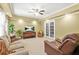 Spacious living room featuring a ceiling fan, neutral carpet, and a view to a sunroom at 3059 Brookgreen Trl, Lawrenceville, GA 30043