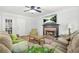 Comfortable living room featuring a brick fireplace, hardwood floors, and ample seating at 3059 Brookgreen Trl, Lawrenceville, GA 30043